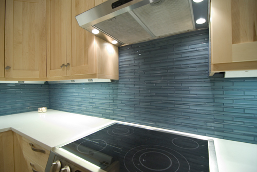After kitchen photo with light tan cabinetry, blue tile and stainless appliances - view 2