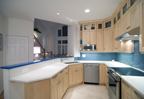 After kitchen photo with light tan cabinetry, blue tile and stainless appliances - view 3