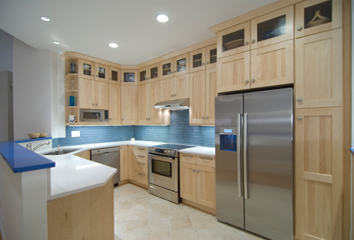After kitchen photo with light tan cabinetry, blue tile and stainless appliances - view 4