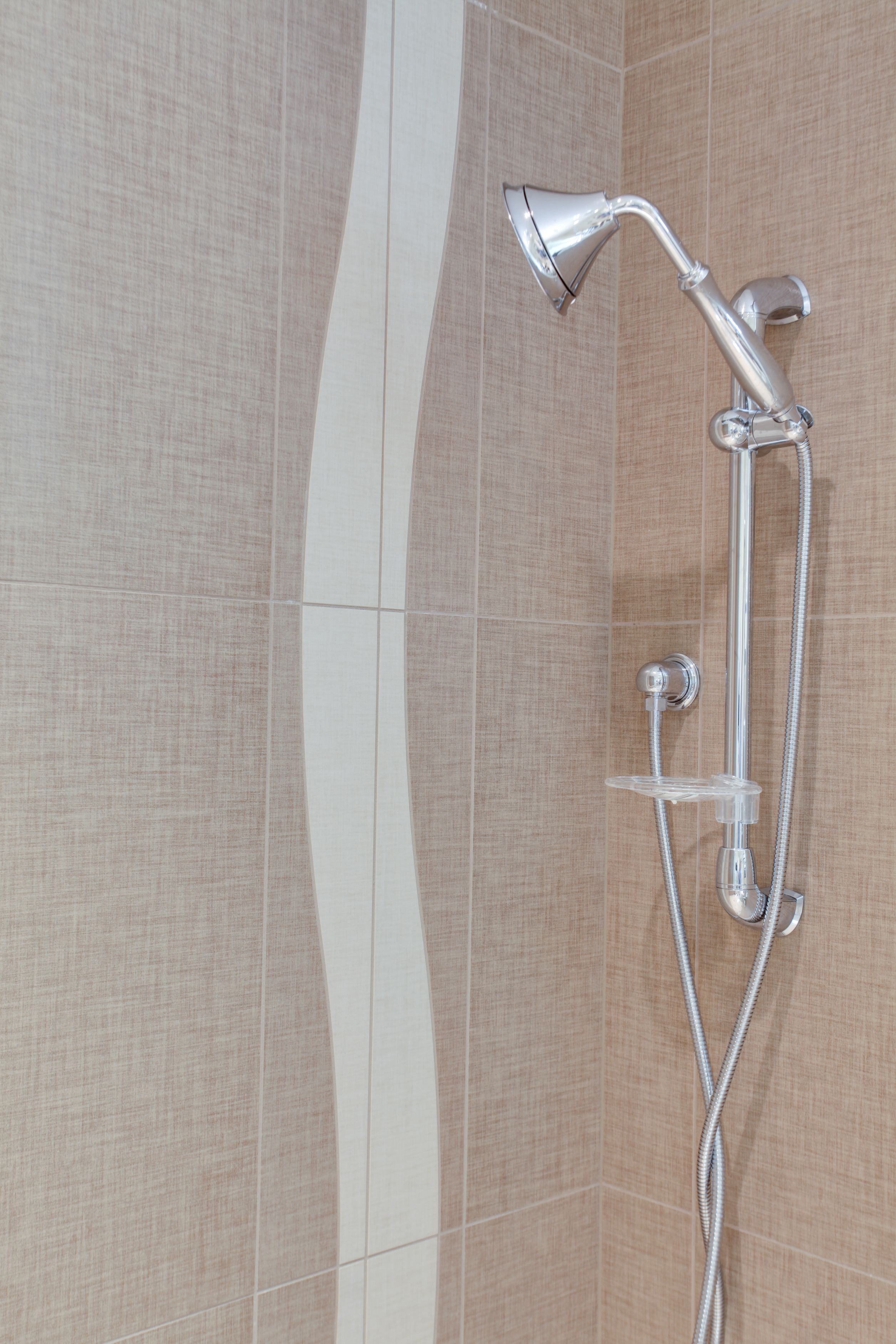 Shower with brown tile and shower hardware