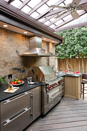 Outdoor kitchen iwth stainless cabinets and black countertops - view 1