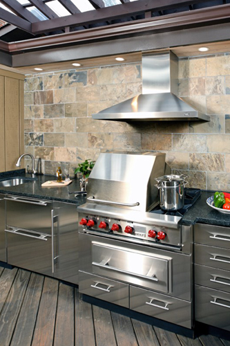 Outdoor kitchen iwth stainless cabinets and black countertops - view 3 - focus on grill and hood