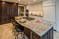 Thumbnail of kitchen with brown cabnietry and granite countertops